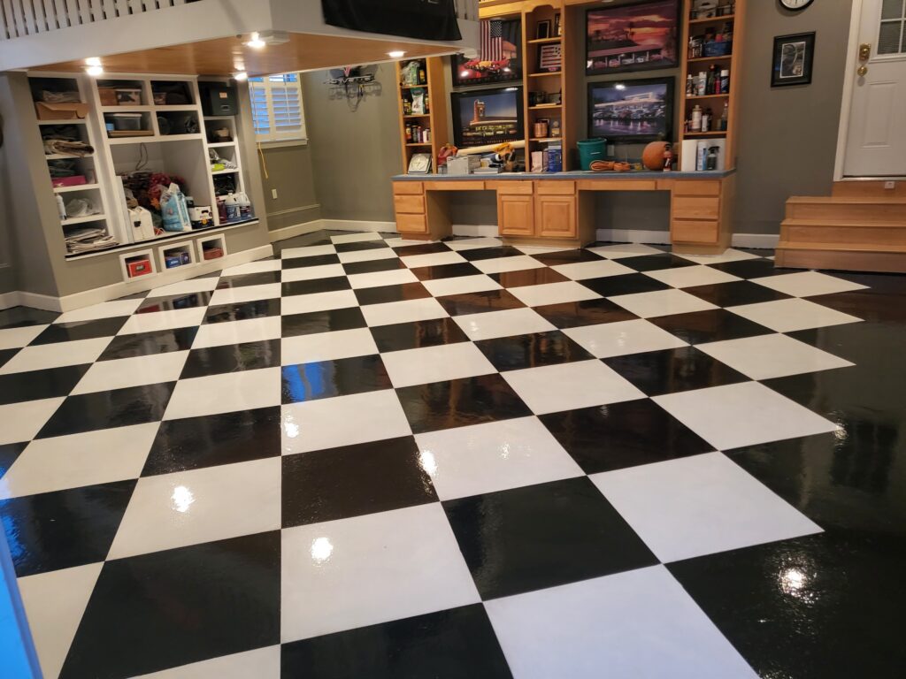 Image of a newly coated Resinous 123 garage floor with a glossy, seamless finish and checkerboard pattern.