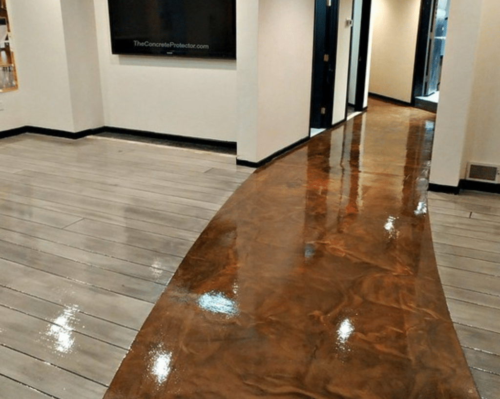 Image of a Metallic Marble Epoxy flooring system with a Weathered Gray Rustic Concrete Wood pattern, showcasing a unique combination of two flooring systems with a glossy, reflective surface, providing a durable and attractive surface for a variety of settings.