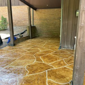 Flagstone Stamped Concrete Patio - A decorative and durable flooring option for outdoor spaces, mimicking the natural beauty of flagstone with a stamped concrete design.